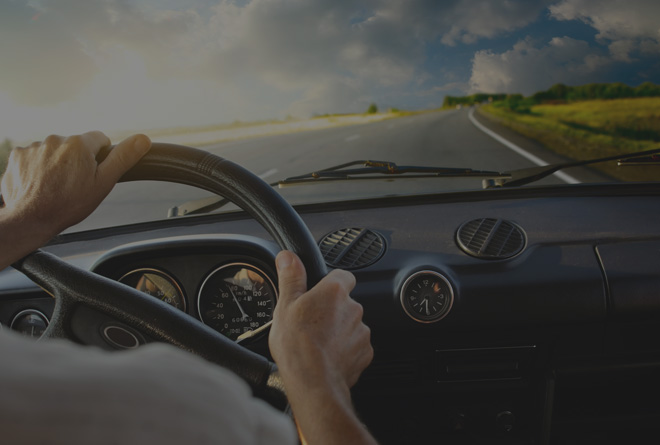 man driving car on a clear road