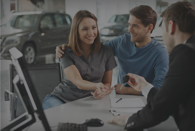 couple getting keys to a new car